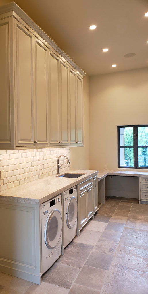 side by side washer dryer in laundry space