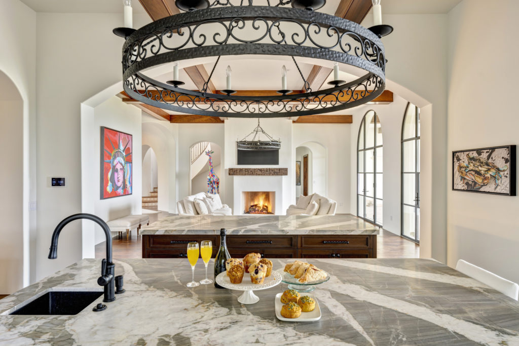 custom kitchen counters and islands with wrought iron chandelier