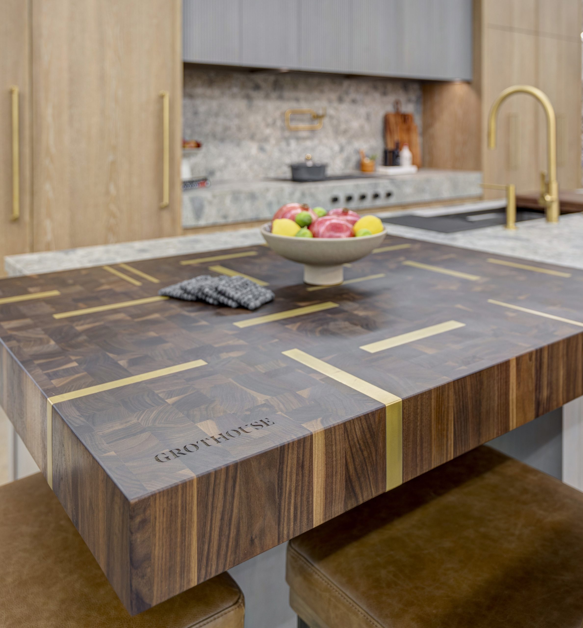 Custom kitchen island with walnut top with satin brass inlay