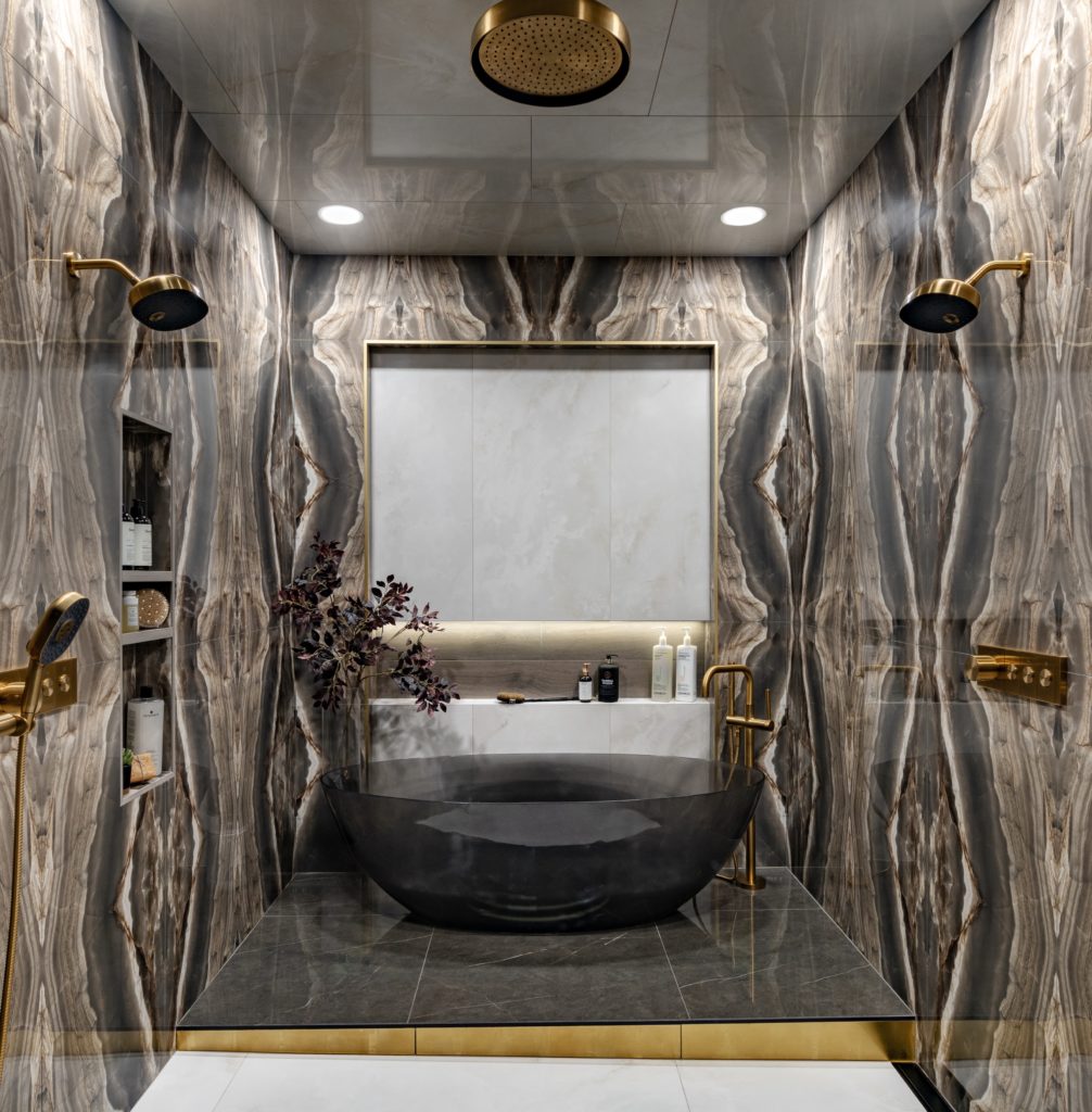 Shower and bathtub surrounded by bookmatched marble