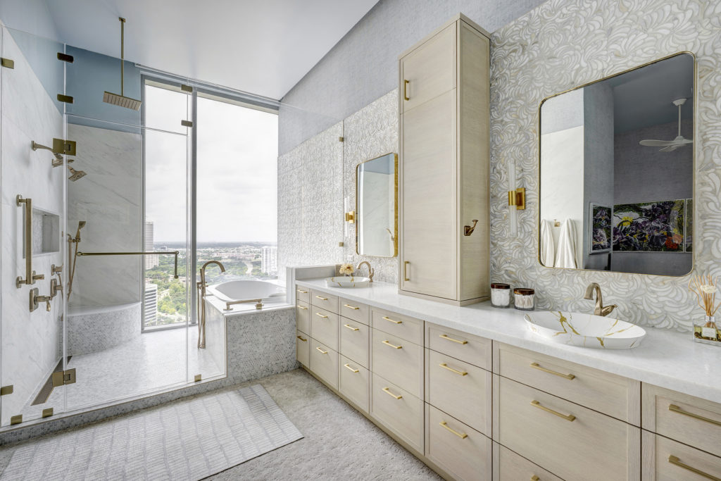 31_2w In the primary bath, the Bonn door in Rift Cut White Oak with Pearl Stain brings warmth and quiet sophistication.