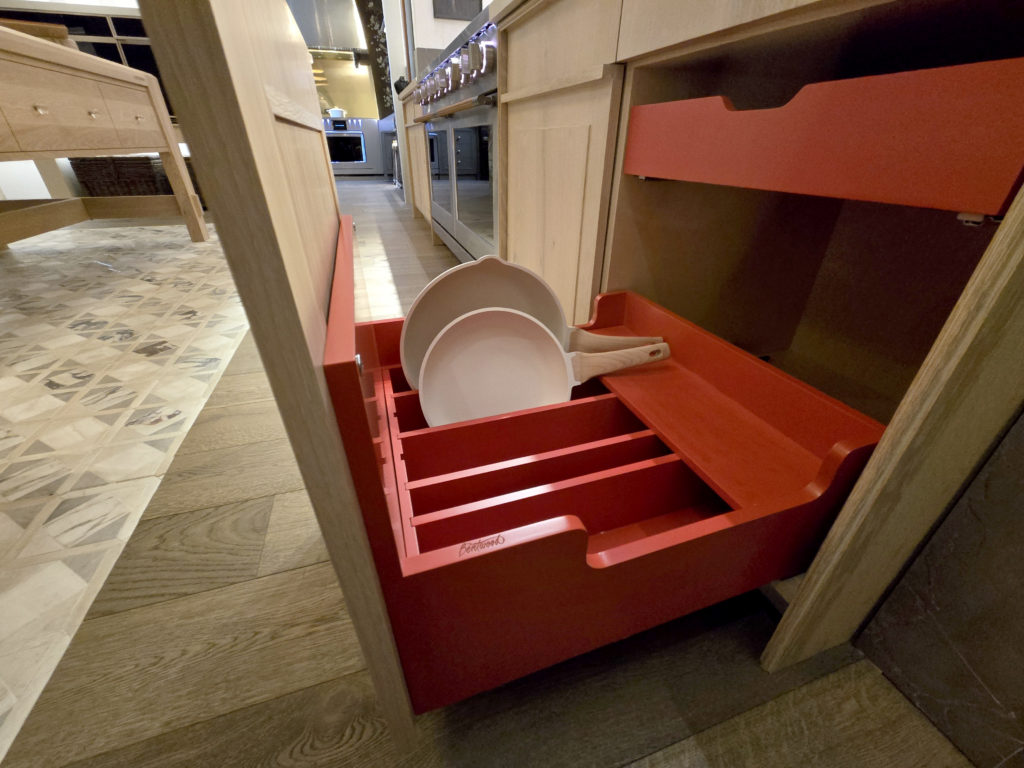 20260219_084101 copy A cast iron pullout scales up the traditional slide-out drawer for heavy Dutch ovens, reducing the lift height significantly. Lids store neatly in the upper drawer.