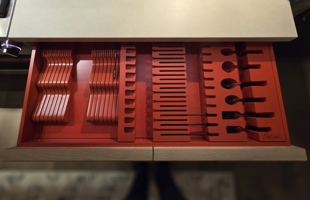 Bentwood-KBIS2026-Large-Cutlery-No-Mark CROP a flatware drawer custom-designed for settings of 12 includes compartments for every piece, including steak knives with an elongated-base cutout.