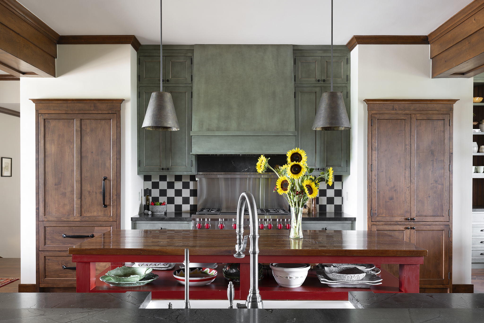 5w The central gas range is flanked on either side by cherry wood cabinets