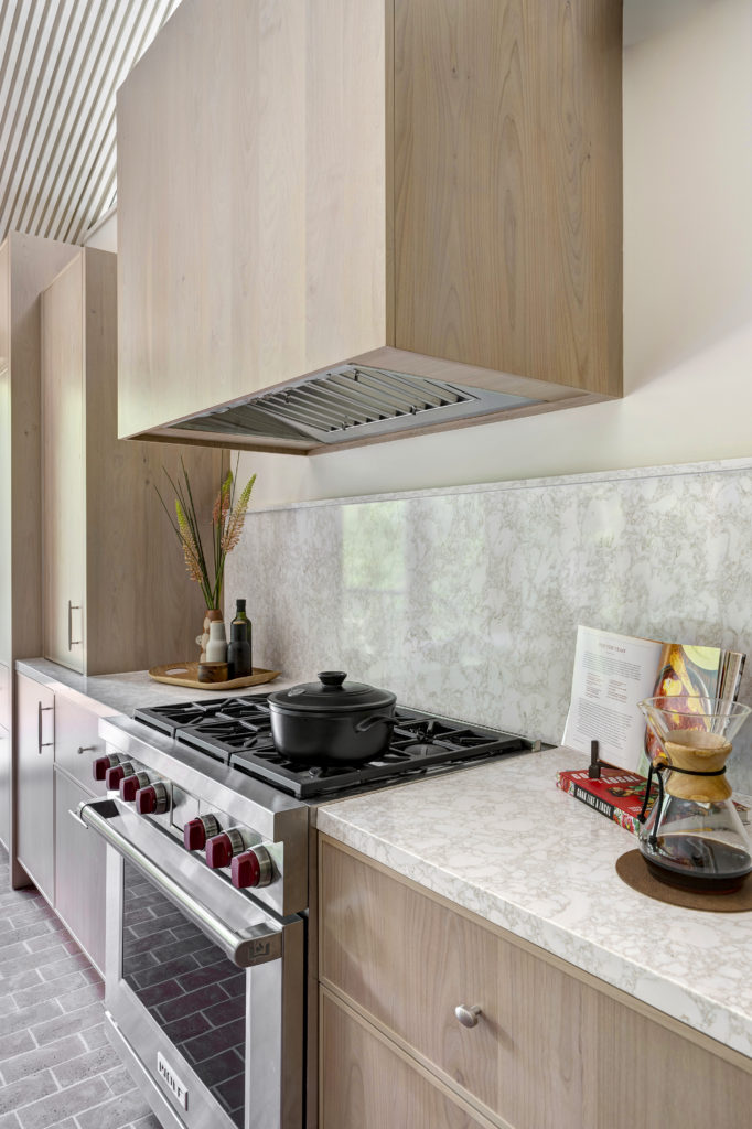 18w Wolf range. The Wolf vent is encased in warm alder cabinetry