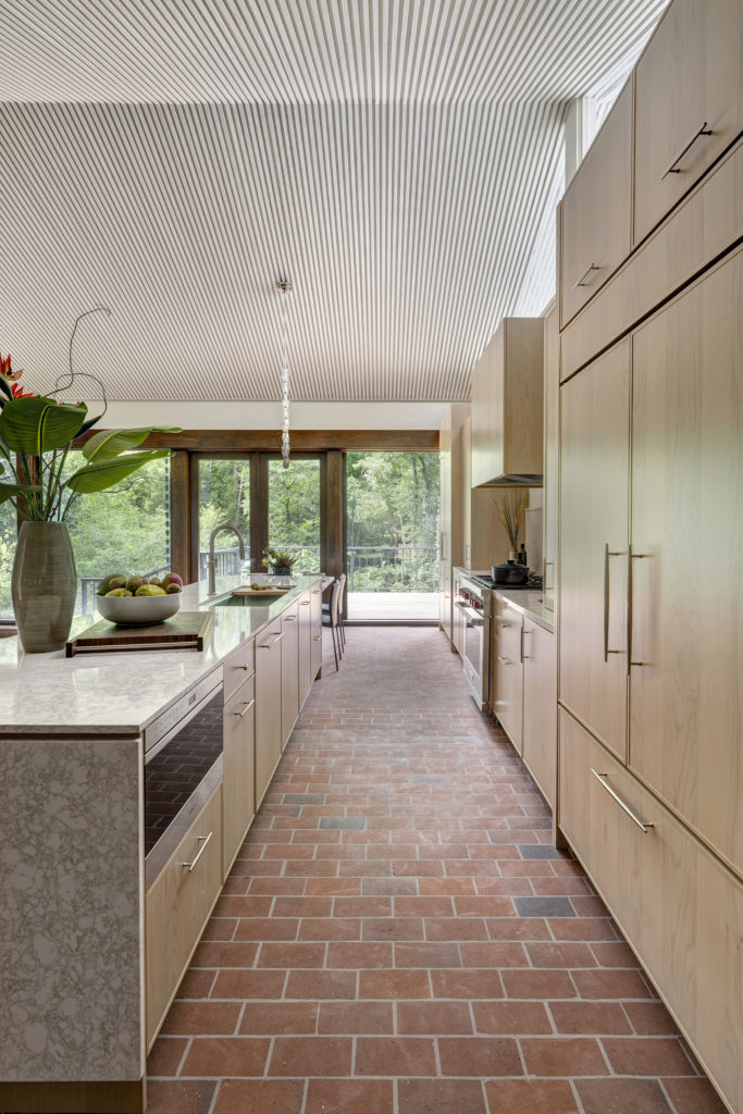 1w Warm alder cabinetry in the Elegante door style lines the perimeter beautifully.