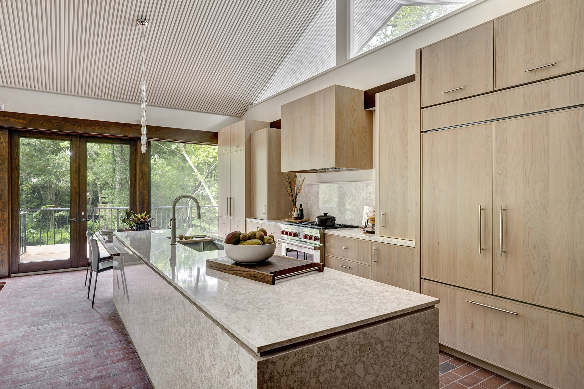 20w Kitchen cabinetry in Elegante door in Alder with Sandstone stain, Top Knob pulls, Cambria countertop