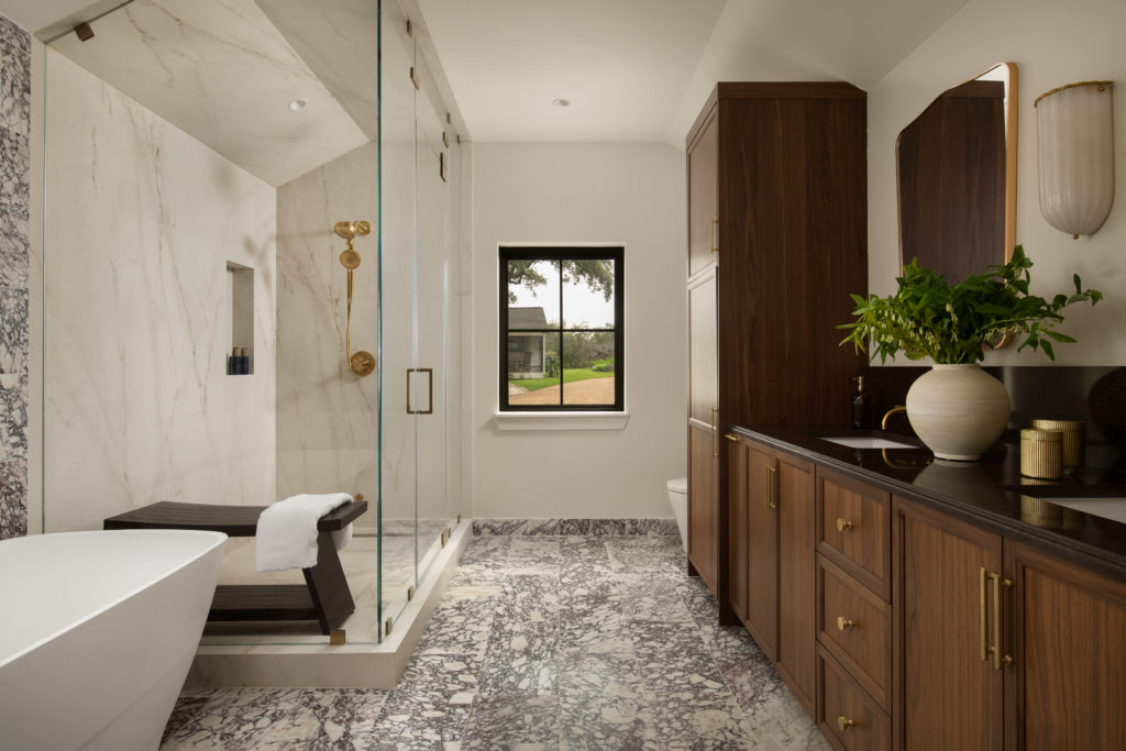 Stardust-Ranch-Texas-2026-5 The en suite with custom bentwood cabinets along one wall facing the shower and freestanding tub